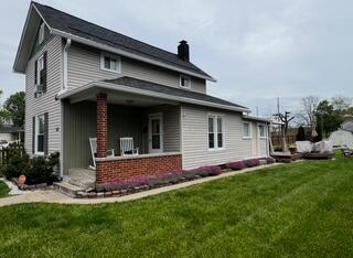 44 King Ave, Newark, OH 43055 - view of side of home with a chimney, a lawn, and brick siding