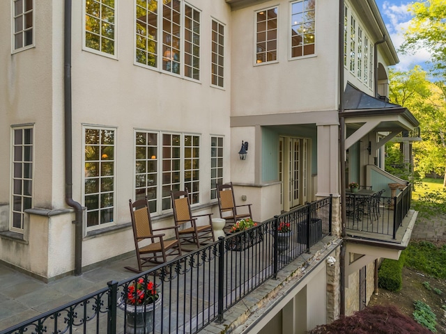 rear view of house with stucco siding and a patio area