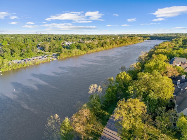 bird's eye view of a nearby body of water and a heavily wooded area