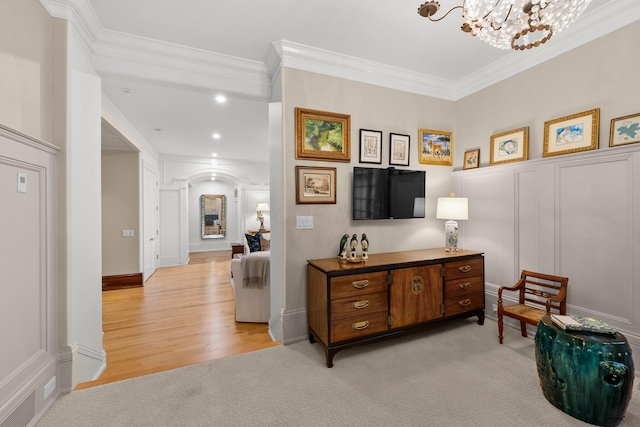 sitting room featuring ornamental molding, arched walkways, a chandelier, light wood finished floors, and recessed lighting