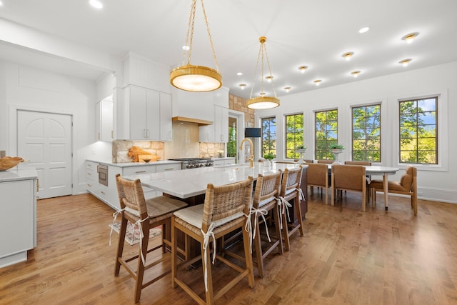 dining area with light wood finished floors and recessed lighting