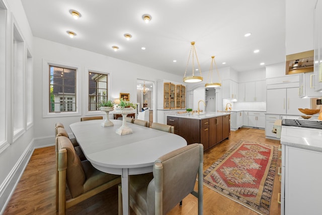 dining area with wood finished floors, baseboards, and recessed lighting