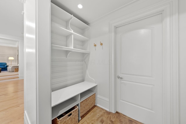 mudroom featuring wood finished floors, crown molding, and recessed lighting