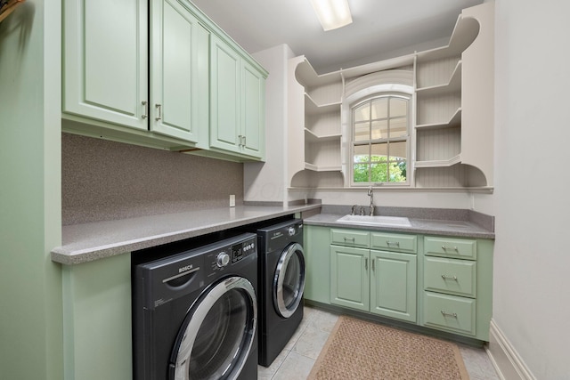 washroom with cabinet space, washer and dryer, and light tile patterned flooring