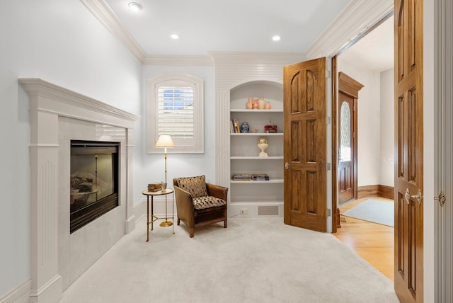 sitting room featuring crown molding, baseboards, carpet flooring, recessed lighting, and a fireplace