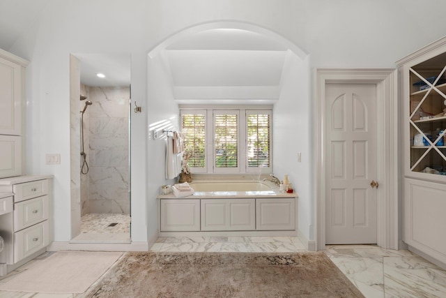 full bathroom with marble finish floors, a marble finish shower, a bath, and baseboards
