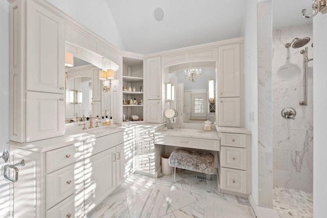 bathroom featuring a tile shower, vaulted ceiling, a chandelier, vanity, and marble finish floors