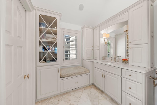 bathroom with marble look tiles and vanity