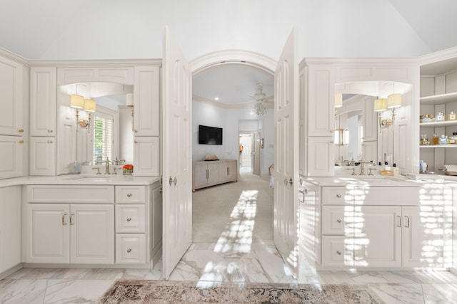 bathroom featuring marble finish flooring, ceiling fan, vanity, vaulted ceiling, and crown molding