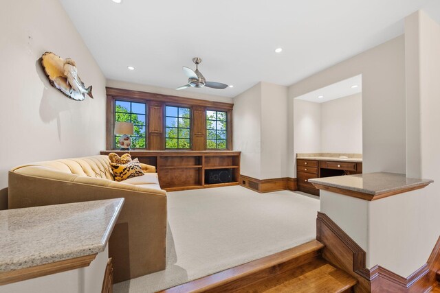 carpeted living area with a ceiling fan and recessed lighting