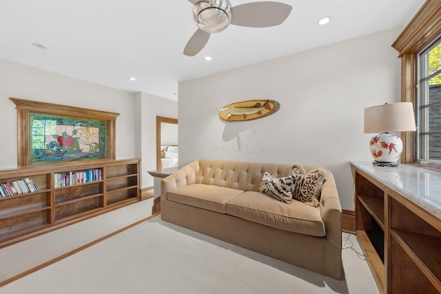 living area with ceiling fan, recessed lighting, and light colored carpet