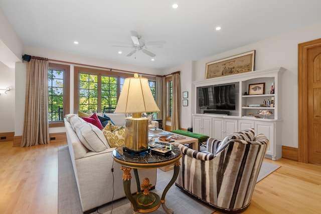 living room featuring light wood-style floors, recessed lighting, a ceiling fan, and baseboards