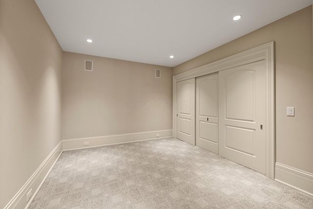 unfurnished bedroom featuring recessed lighting, carpet, a closet, and baseboards