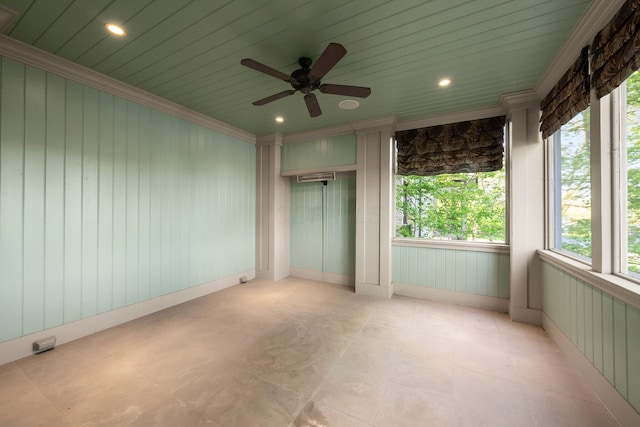 unfurnished bedroom with ornamental molding, a ceiling fan, recessed lighting, and wooden walls