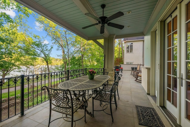 view of patio with outdoor dining space and a ceiling fan