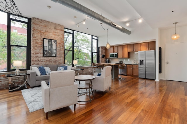 78 E Chestnut St Unit 205, Columbus, OH 43215 - living area featuring a high ceiling, wood finished floors, and track lighting