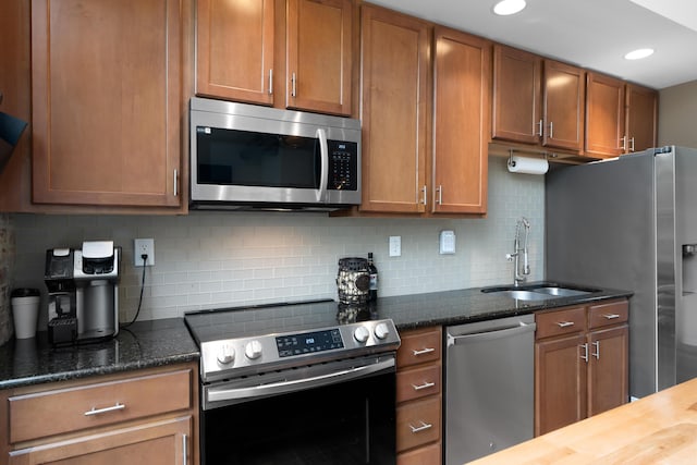 78 E Chestnut St Unit 205, Columbus, OH 43215 - kitchen with stainless steel appliances, a sink, backsplash, and brown cabinets