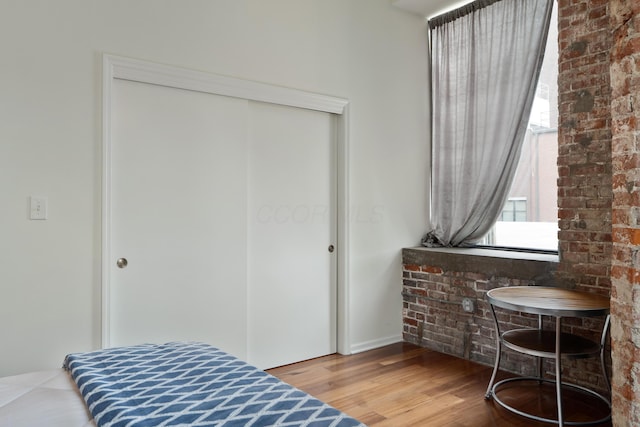 78 E Chestnut St Unit 205, Columbus, OH 43215 - bedroom with a closet, wood finished floors, and baseboards