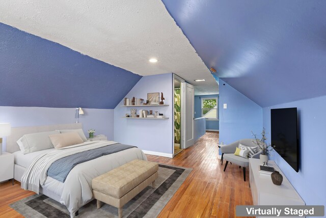 3204 Mcguffey Rd, Columbus, OH 43224 - bedroom featuring a textured ceiling, hardwood / wood-style floors, vaulted ceiling, and baseboards