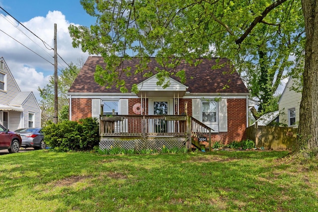 3204 Mcguffey Rd, Columbus, OH 43224 - view of front of property with brick siding, a deck, and roof with shingles