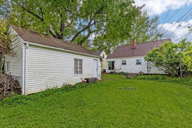 3204 Mcguffey Rd, Columbus, OH 43224 - rear view of property featuring a lawn and a chimney