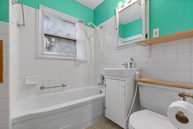 3204 Mcguffey Rd, Columbus, OH 43224 - full bathroom with toilet, washtub / shower combination, tile walls, vanity, and tile patterned flooring
