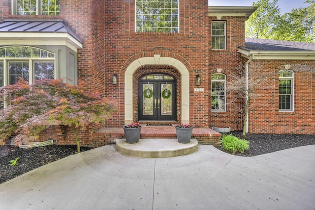 3720 Hyatts Rd, Powell, OH 43065 - view of exterior entry featuring french doors, brick siding, and a standing seam roof