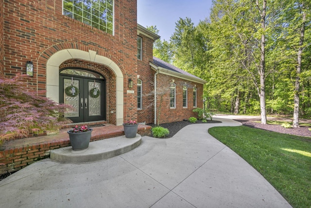 3720 Hyatts Rd, Powell, OH 43065 - doorway to property featuring french doors, brick siding, and a yard