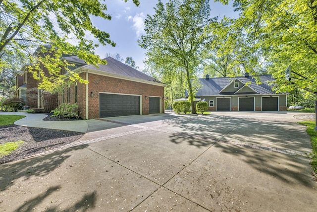 3720 Hyatts Rd, Powell, OH 43065 - view of home's exterior featuring driveway, brick siding, and an attached garage
