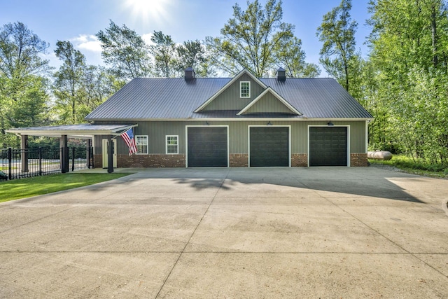 3720 Hyatts Rd, Powell, OH 43065 - view of front of property with a chimney, fence, driveway, metal roof, and brick siding
