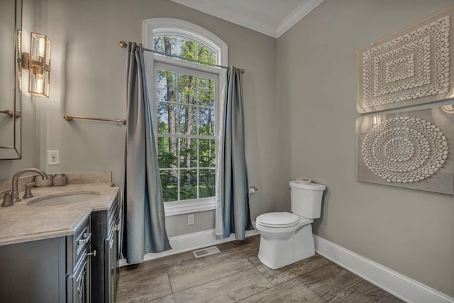 3720 Hyatts Rd, Powell, OH 43065 - bathroom with ornamental molding, baseboards, toilet, vanity, and wood finished floors