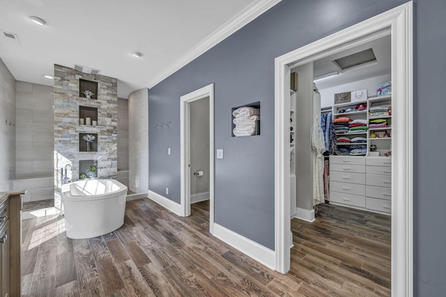 3720 Hyatts Rd, Powell, OH 43065 - bathroom with crown molding, a freestanding bath, wood finished floors, baseboards, and a walk in closet