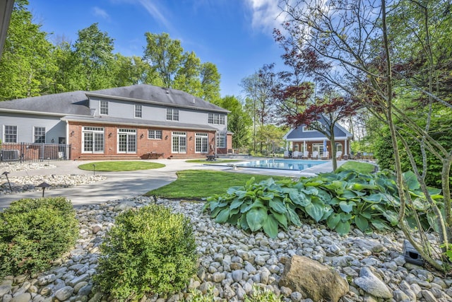 3720 Hyatts Rd, Powell, OH 43065 - back of property featuring brick siding, an outdoor pool, and a patio