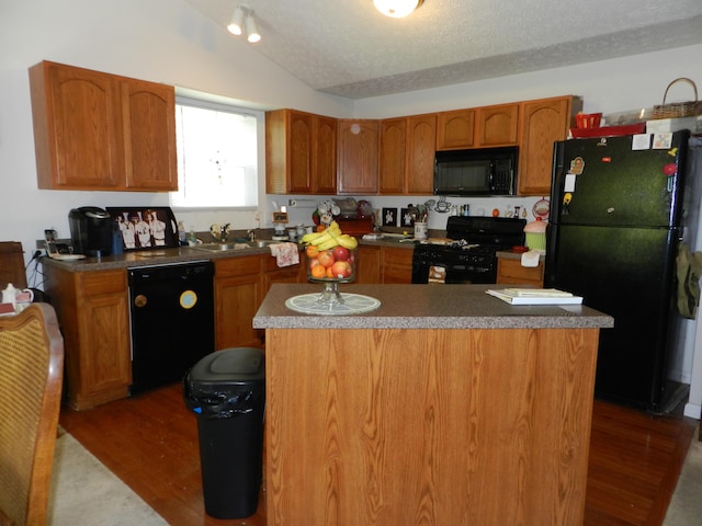 7895 Chapel Stone Rd, Blacklick, OH 43004 - kitchen with black appliances, dark wood-style floors, lofted ceiling, a sink, and brown cabinetry