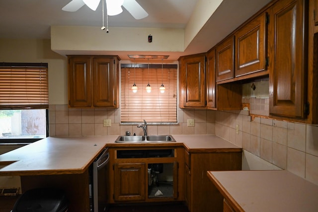 kitchen featuring a sink, tasteful backsplash, light countertops, and ceiling fan