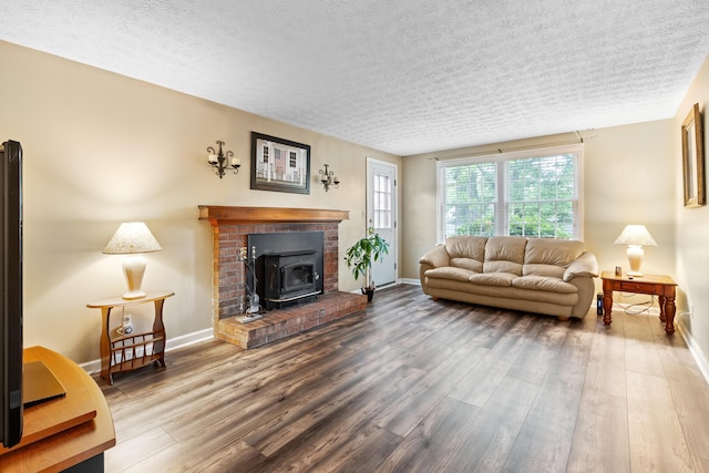 68 Whipple Pl, Westerville, OH 43081 - living room featuring wood finished floors, baseboards, a wood stove, and a textured ceiling