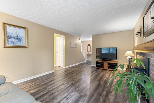 68 Whipple Pl, Westerville, OH 43081 - living room featuring wood finished floors, a textured ceiling, a fireplace, and baseboards