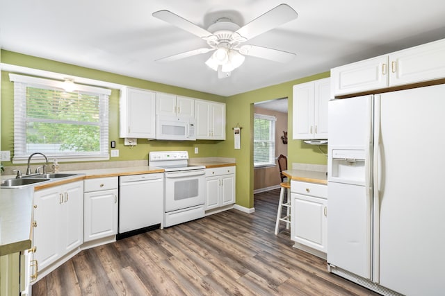 68 Whipple Pl, Westerville, OH 43081 - kitchen featuring white appliances, a sink, white cabinets, and dark wood-style floors