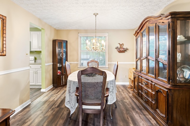 68 Whipple Pl, Westerville, OH 43081 - dining area featuring a chandelier, dark wood-style floors, a textured ceiling, and baseboards