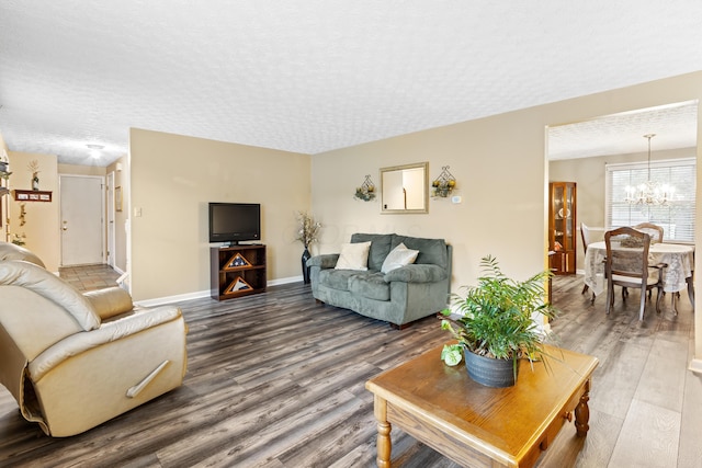 68 Whipple Pl, Westerville, OH 43081 - living room featuring wood finished floors, a chandelier, a textured ceiling, and baseboards