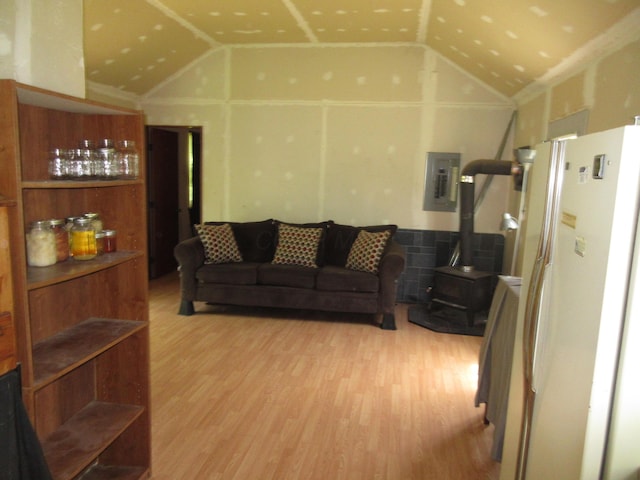 6800 Center Rd, Philo, OH 43771 - living area with a wood stove, wood finished floors, electric panel, and high vaulted ceiling
