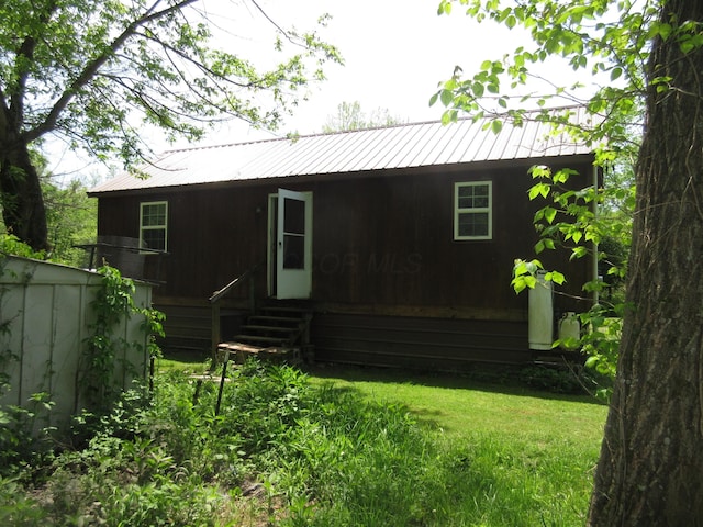 6800 Center Rd, Philo, OH 43771 - rear view of property featuring metal roof and a lawn