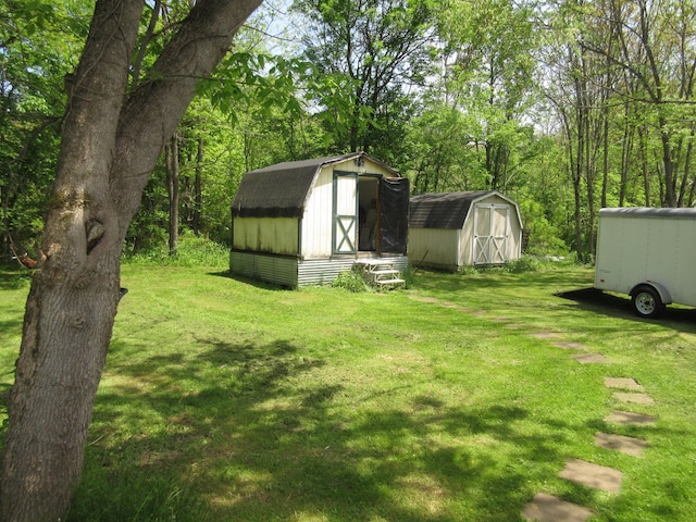 6800 Center Rd, Philo, OH 43771 - view of grassy yard featuring a storage unit and an outbuilding