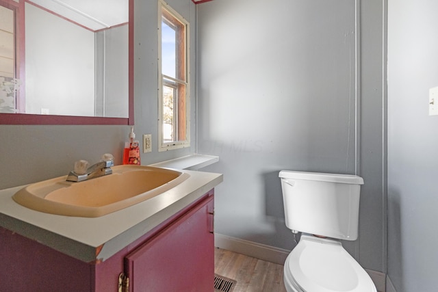 376 Benton Rd, Sycamore, OH 44882 - bathroom featuring wood finished floors, vanity, toilet, and baseboards