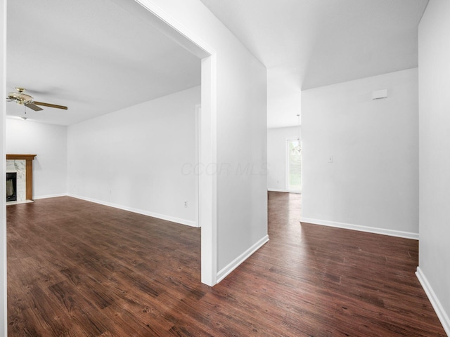 3182 Grey Fox Dr, Columbus, OH 43230 - unfurnished living room with a ceiling fan, a high end fireplace, dark wood-style flooring, and baseboards