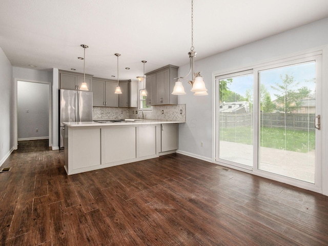 3182 Grey Fox Dr, Columbus, OH 43230 - kitchen featuring gray cabinetry, freestanding refrigerator, a peninsula, light countertops, and dark wood finished floors