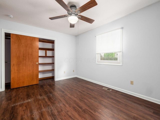 3182 Grey Fox Dr, Columbus, OH 43230 - unfurnished bedroom featuring dark wood-style floors, baseboards, a ceiling fan, and a closet