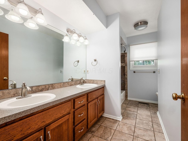 3182 Grey Fox Dr, Columbus, OH 43230 - full bathroom featuring double vanity, shower / bath combination, toilet, and baseboards