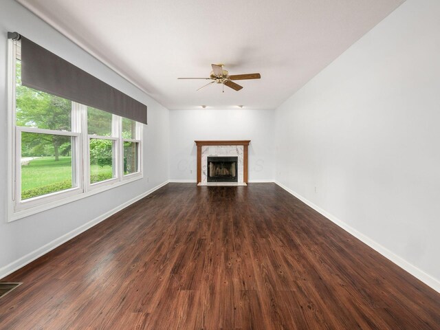 3182 Grey Fox Dr, Columbus, OH 43230 - unfurnished living room with a ceiling fan, dark wood-style floors, a fireplace, and baseboards