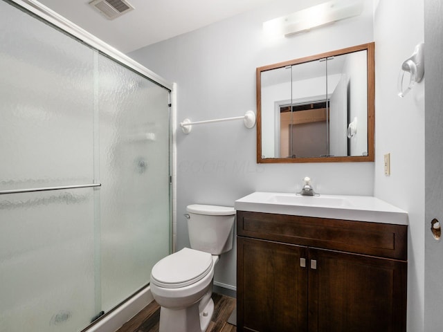 3182 Grey Fox Dr, Columbus, OH 43230 - bathroom featuring wood finished floors, a stall shower, vanity, and toilet